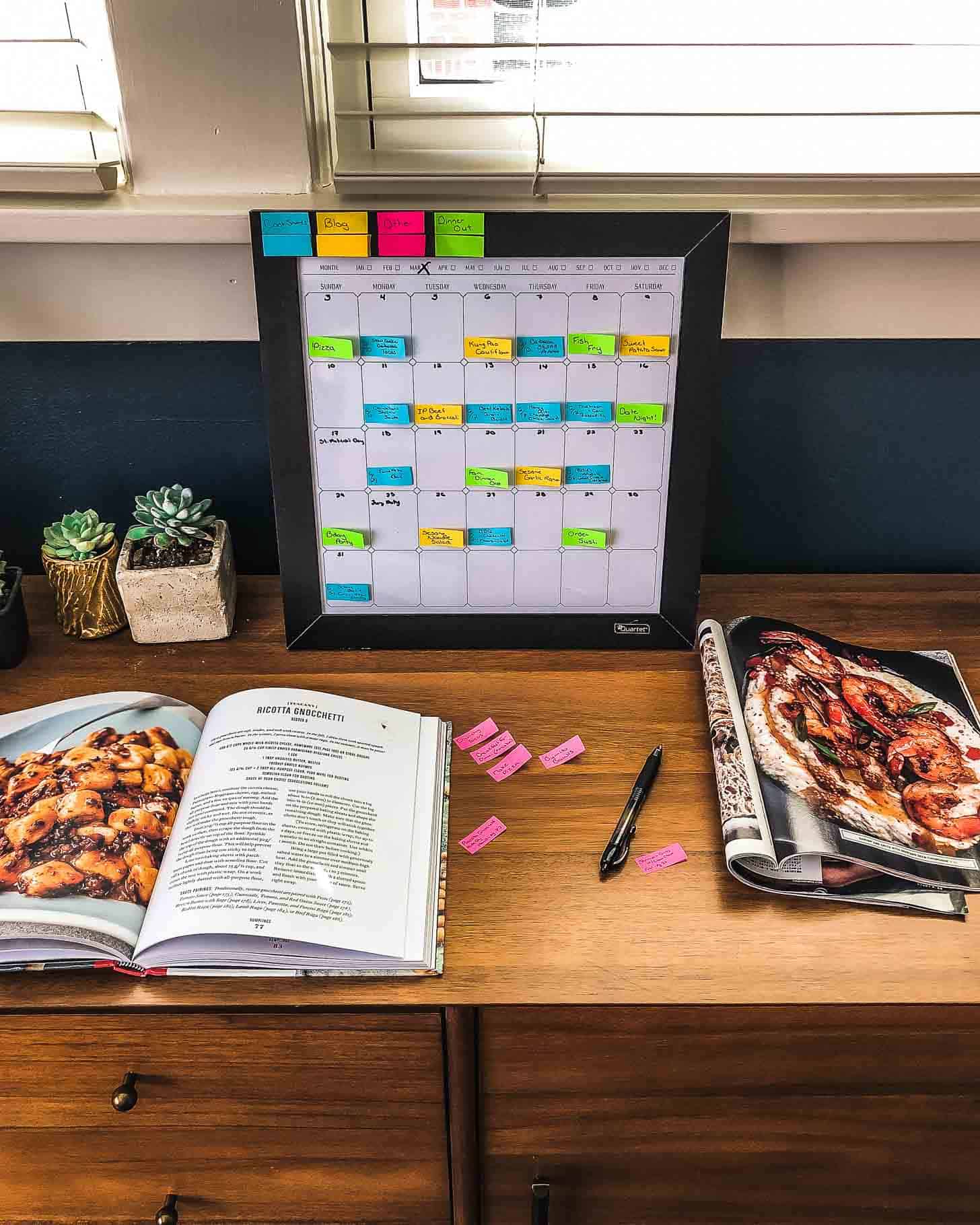 a calendar and cookbooks on a desk