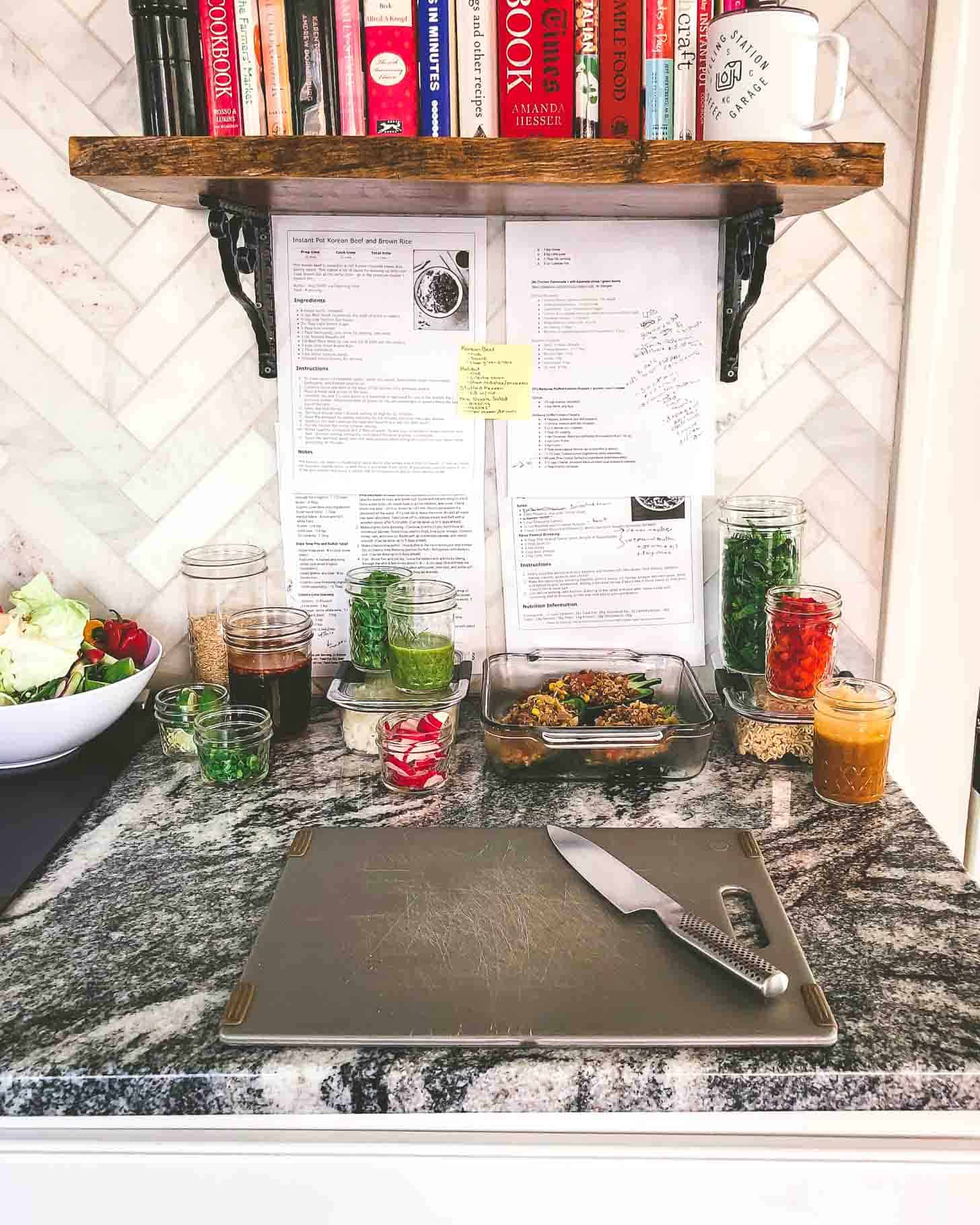 a cutting board and meals prepped