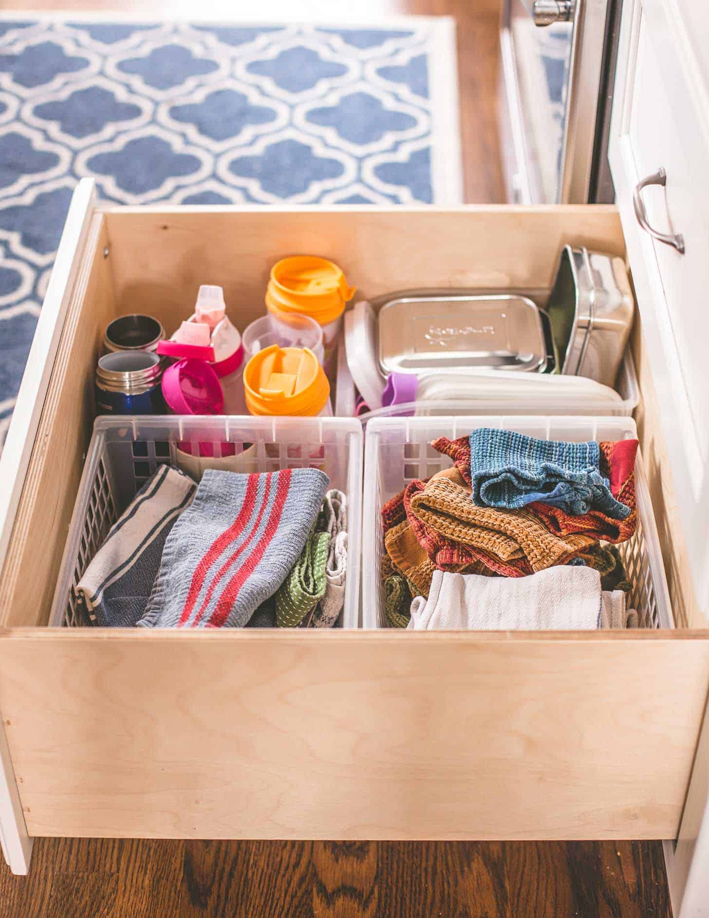 a drawer with dish towels