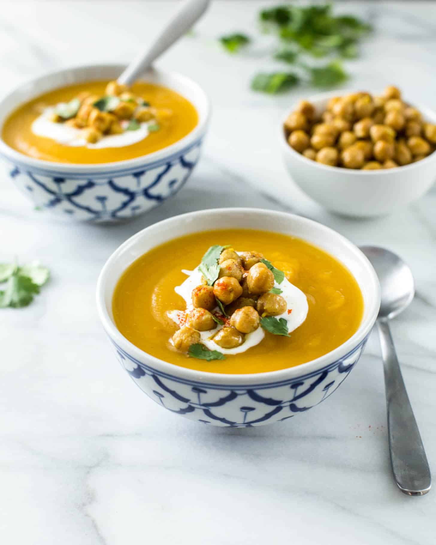 2 bowls of Sweet Potato Soup on a white table