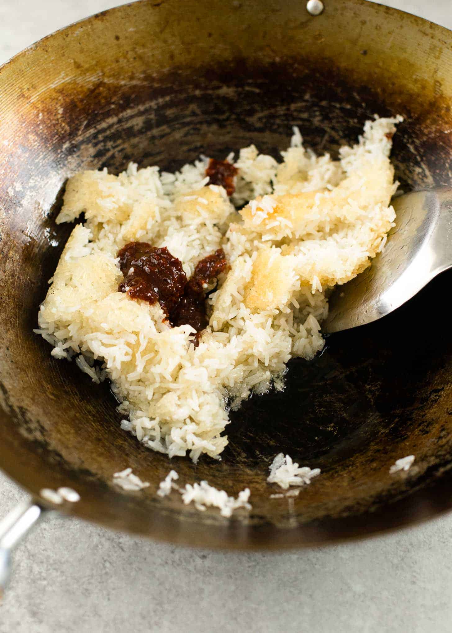 overhead image of Rice with nam prik pao in a wok