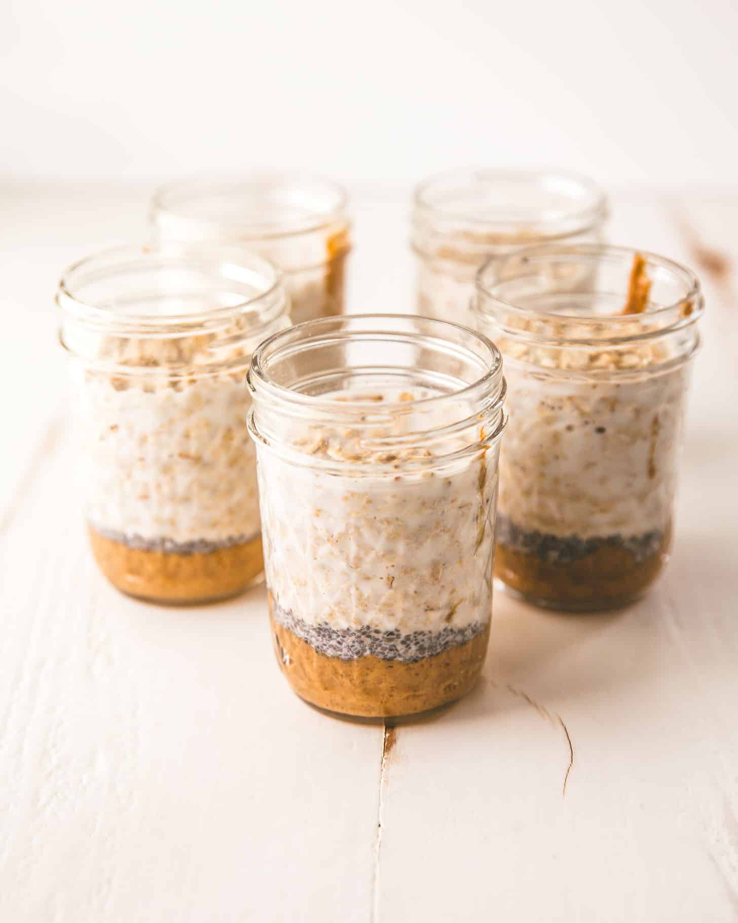 mason jars of overnight oats on a white table