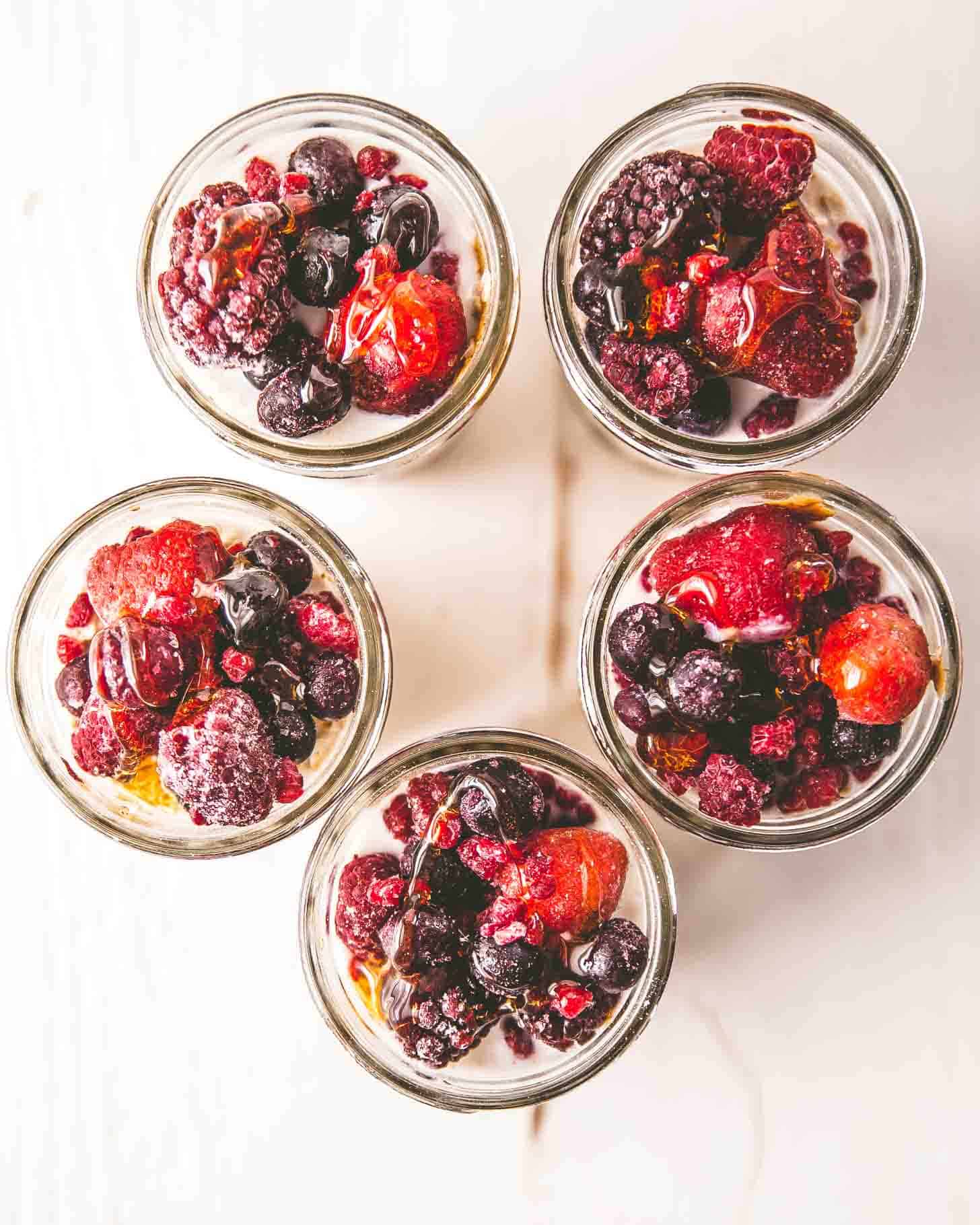 mason jars of overnight oats topped with berries