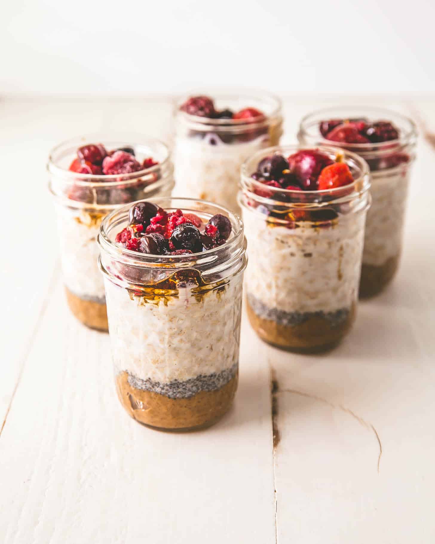 jars of oats and toppings on a white table
