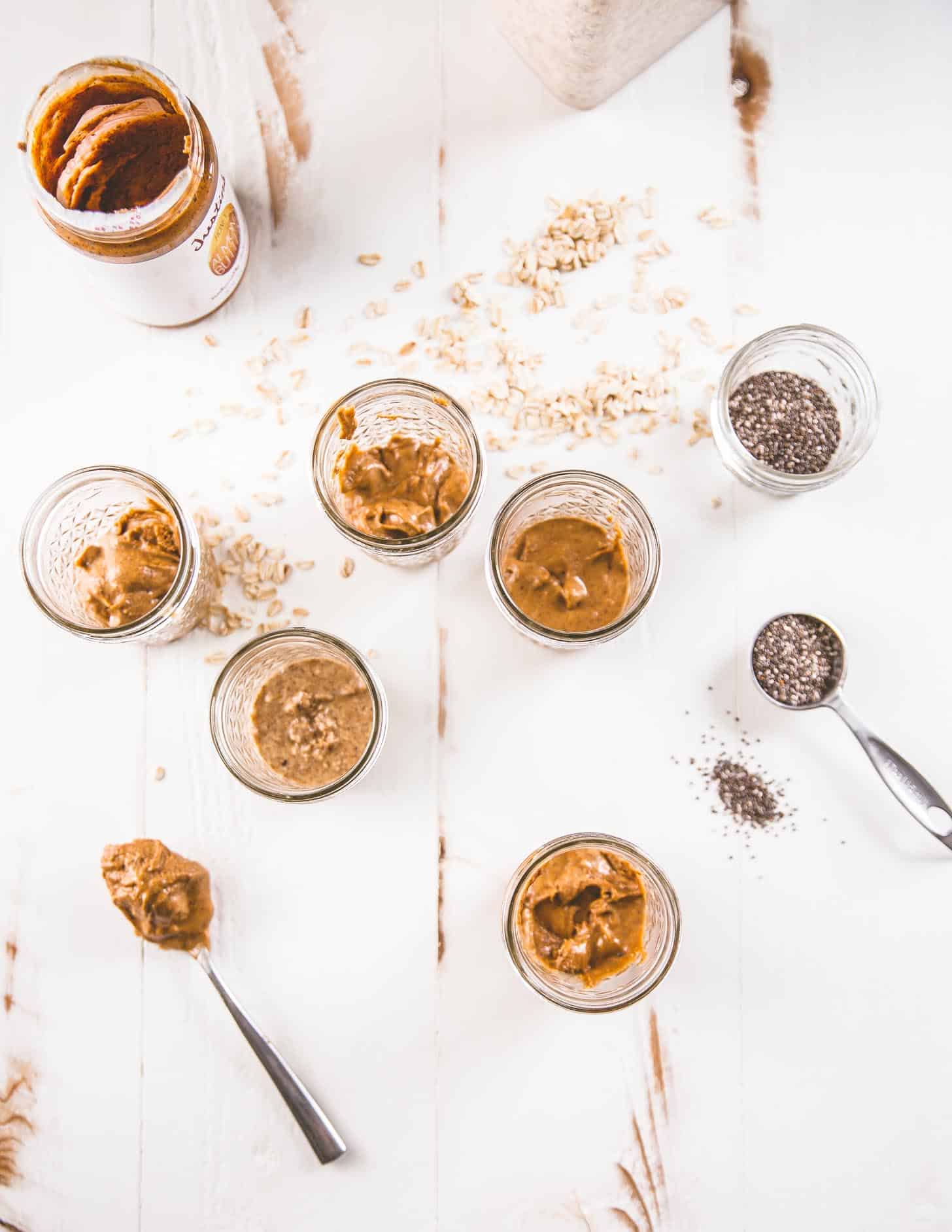 mason jars of peanut butter on a white table