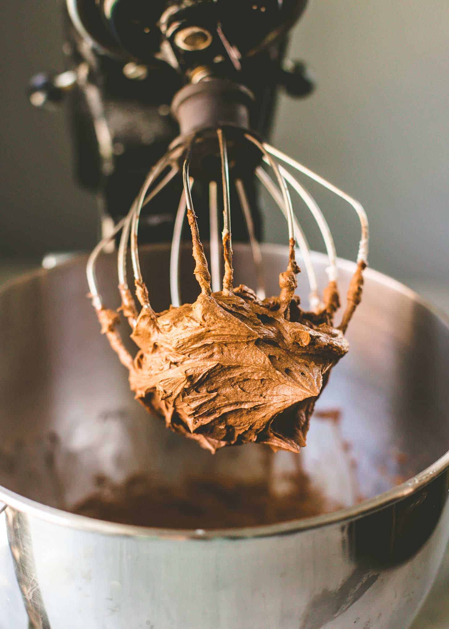 close up image of chocolate frosting on a beater