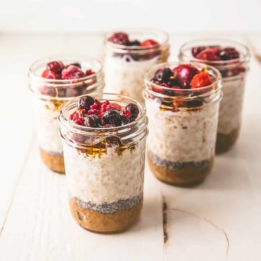 square image overnight oats in mason jars with berries on top
