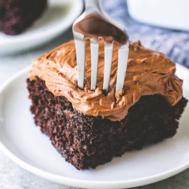 fork taking a slice of chocolate cake with chocolate frosting