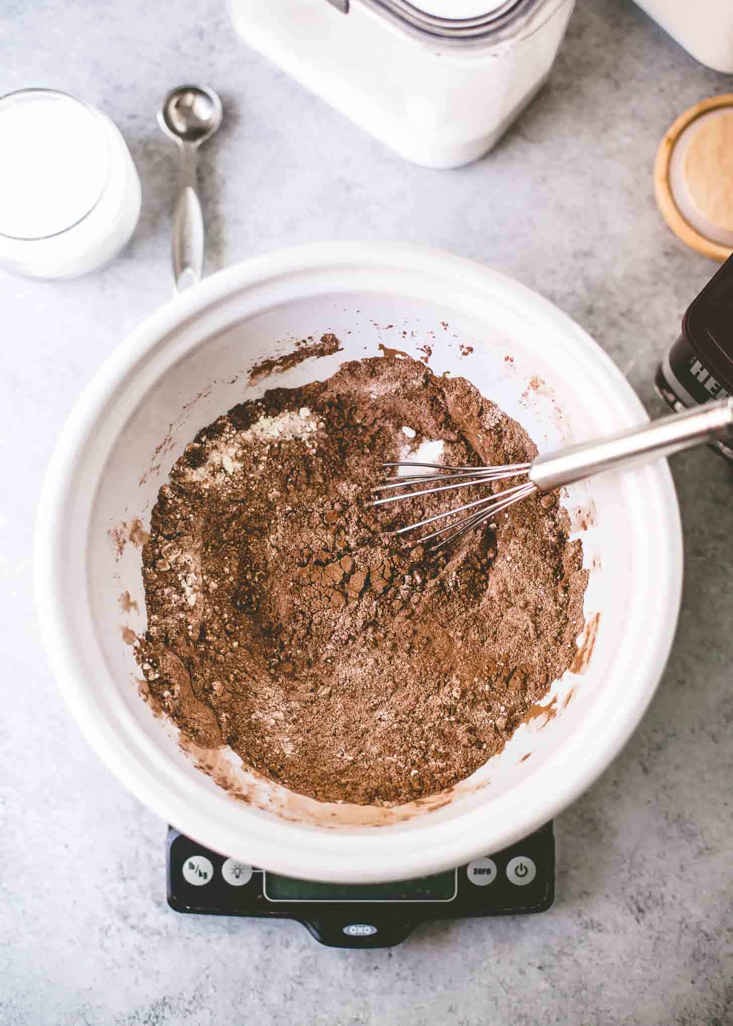 mixing ingredients for cake in a white bowl