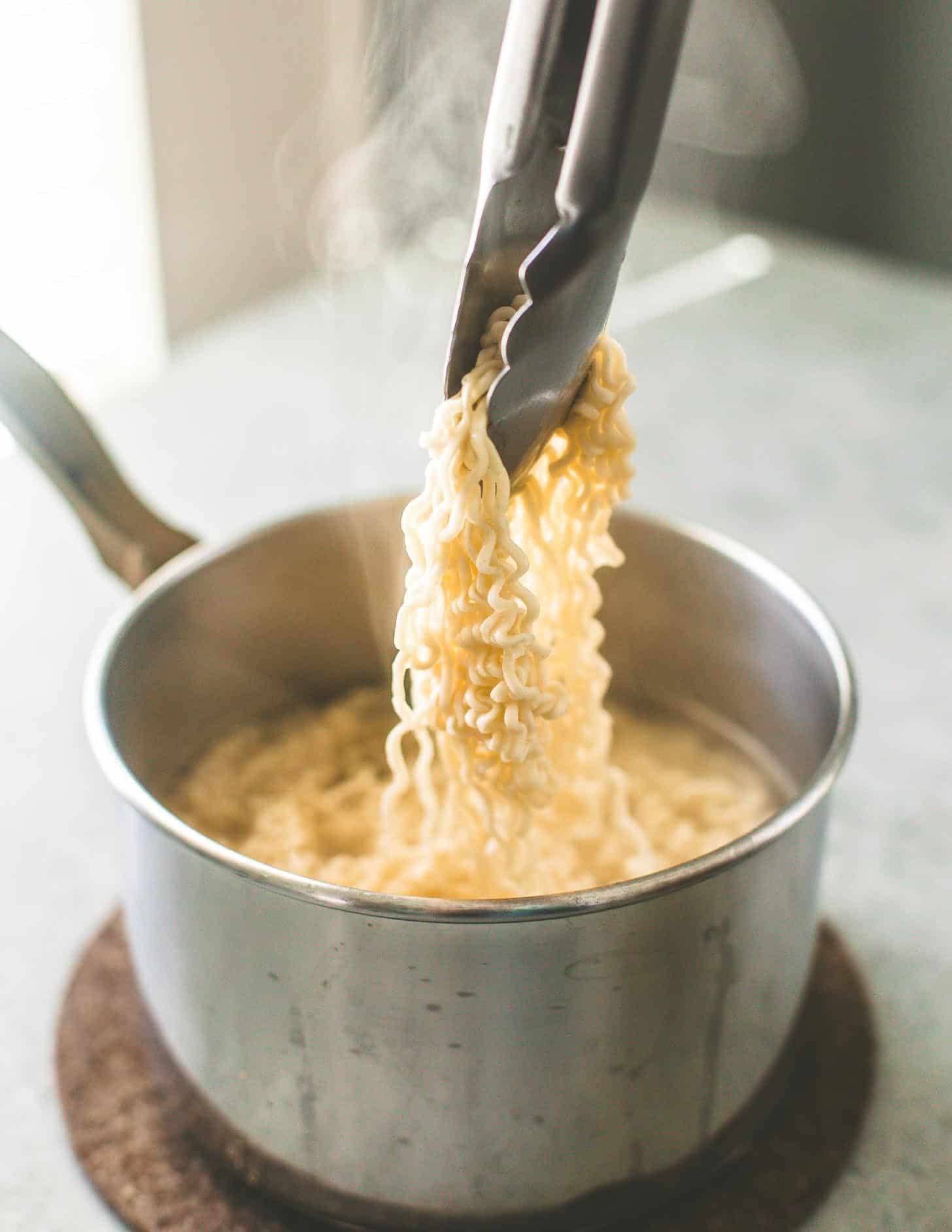 Cooking ramen noodles in a saucepan for stir-fry