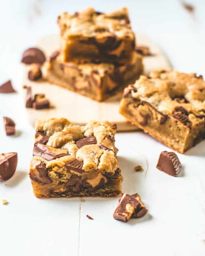 Peanut Butter Cup Cookie Bars stacked on a white table