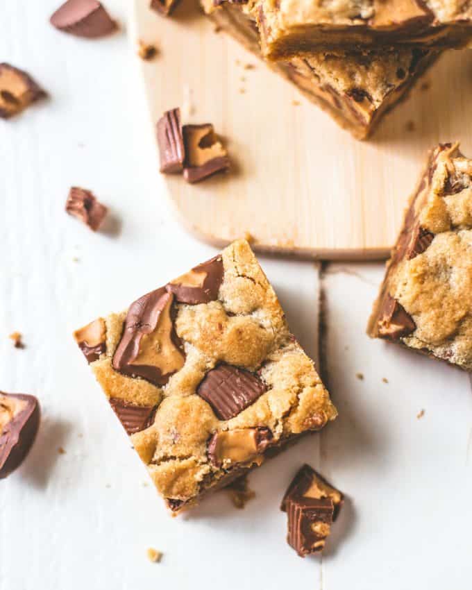 Peanut Butter Cup Cookie Bars on a wooden board
