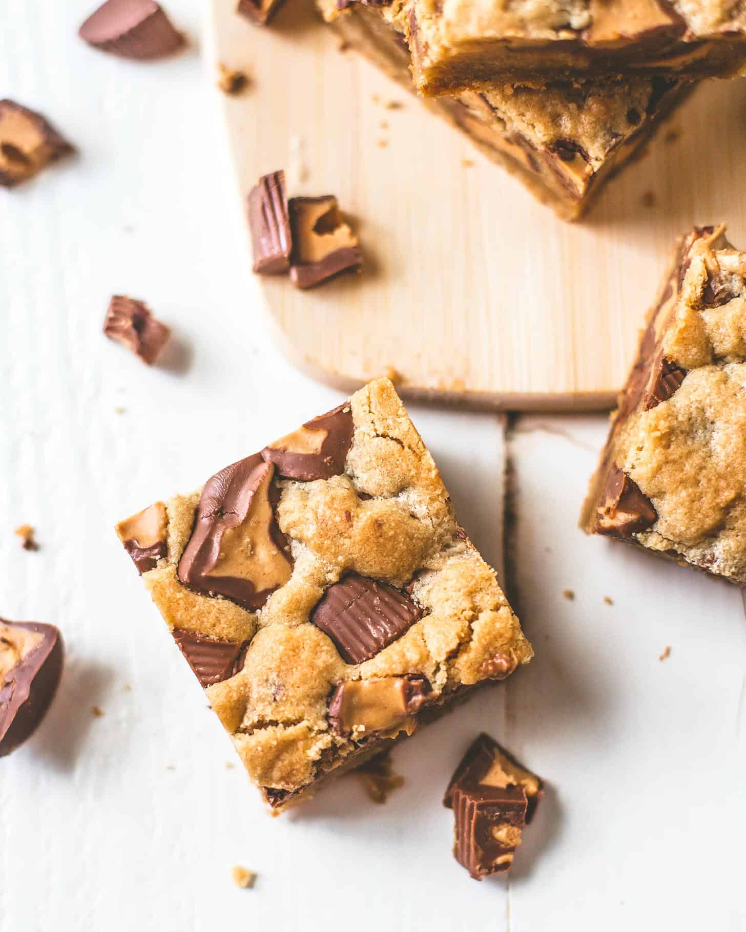 overhead image of Peanut Butter Cup Cookie Bars on a wooden board