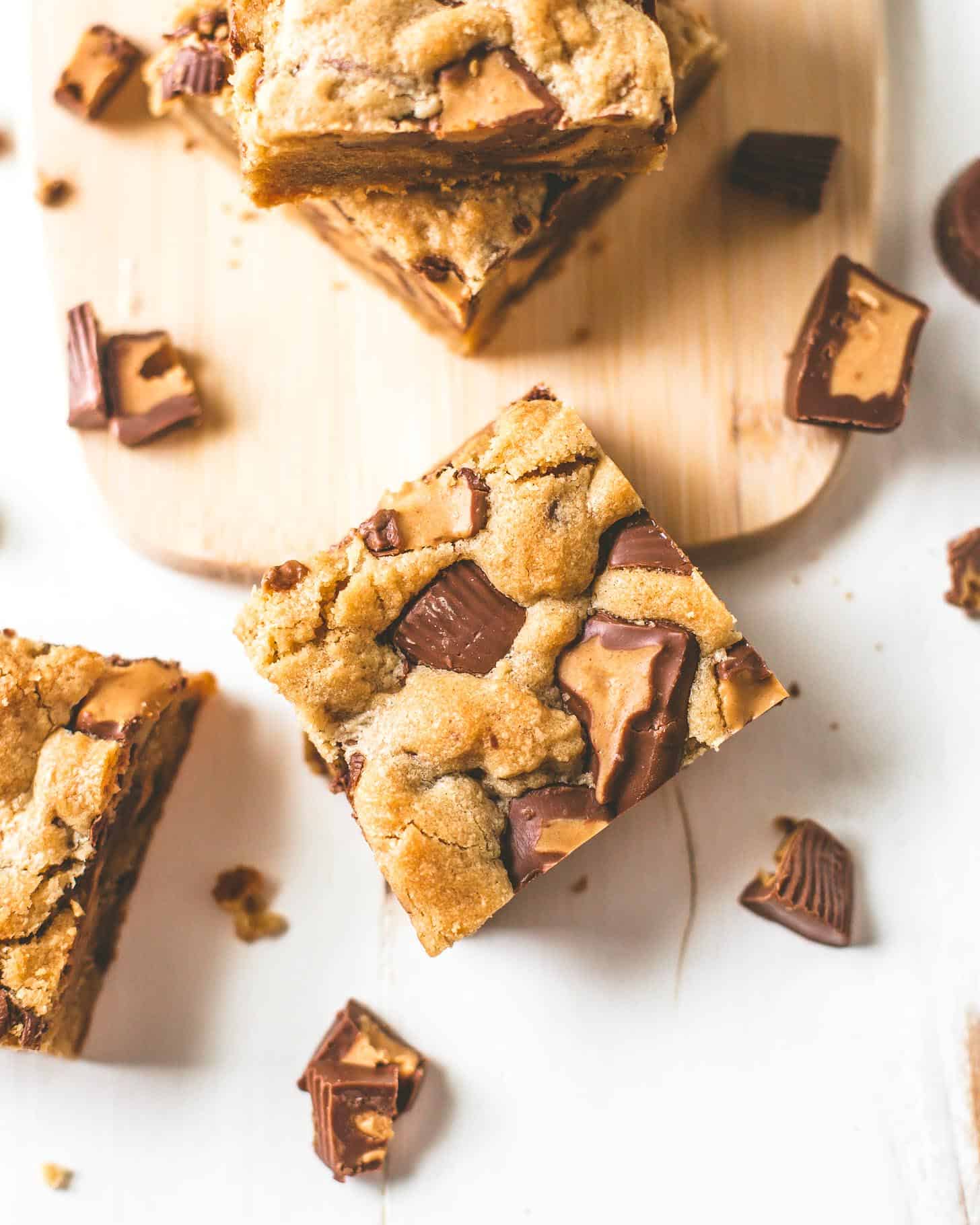 overhead image of Peanut Butter Cup Cookie Bars on a wooden board