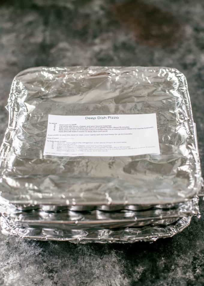 Deep Dish Pizza in a disposable tray with a freezer label