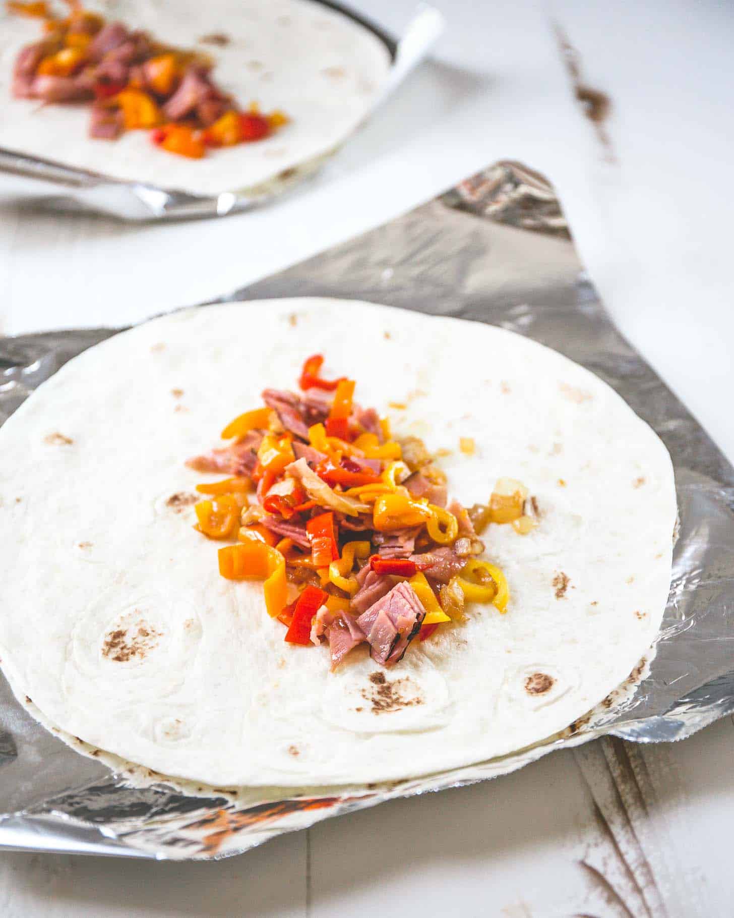 ham, peppers and onions on a tortilla