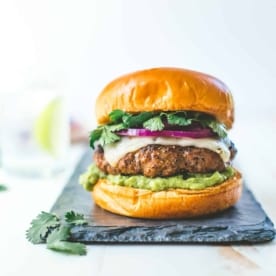 Tex Mex Burgers with Guacamole on a grey slate tray