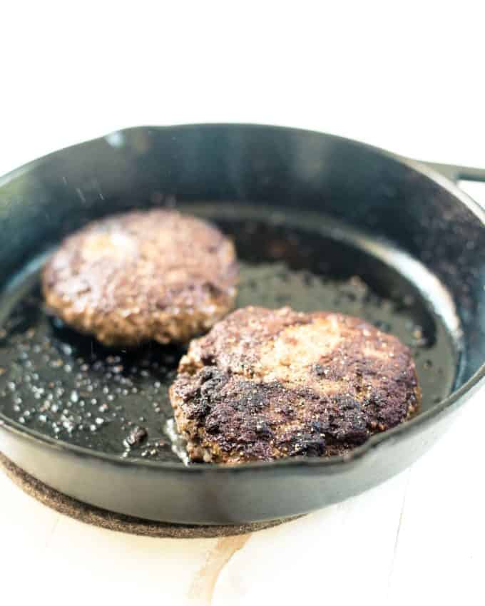 burgers in a cast iron skillet