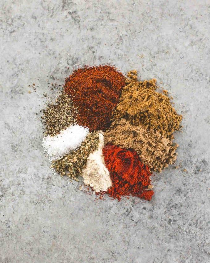 spices for tex mex seasoning on a grey countertop