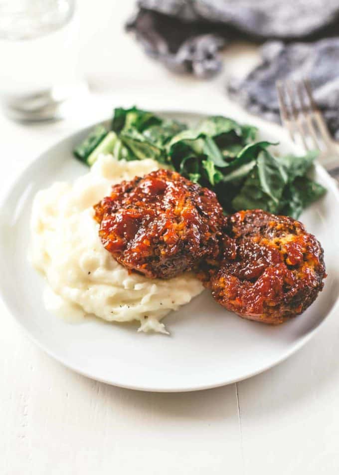 Classic Meatloaf on a white plate with mashed potatoes