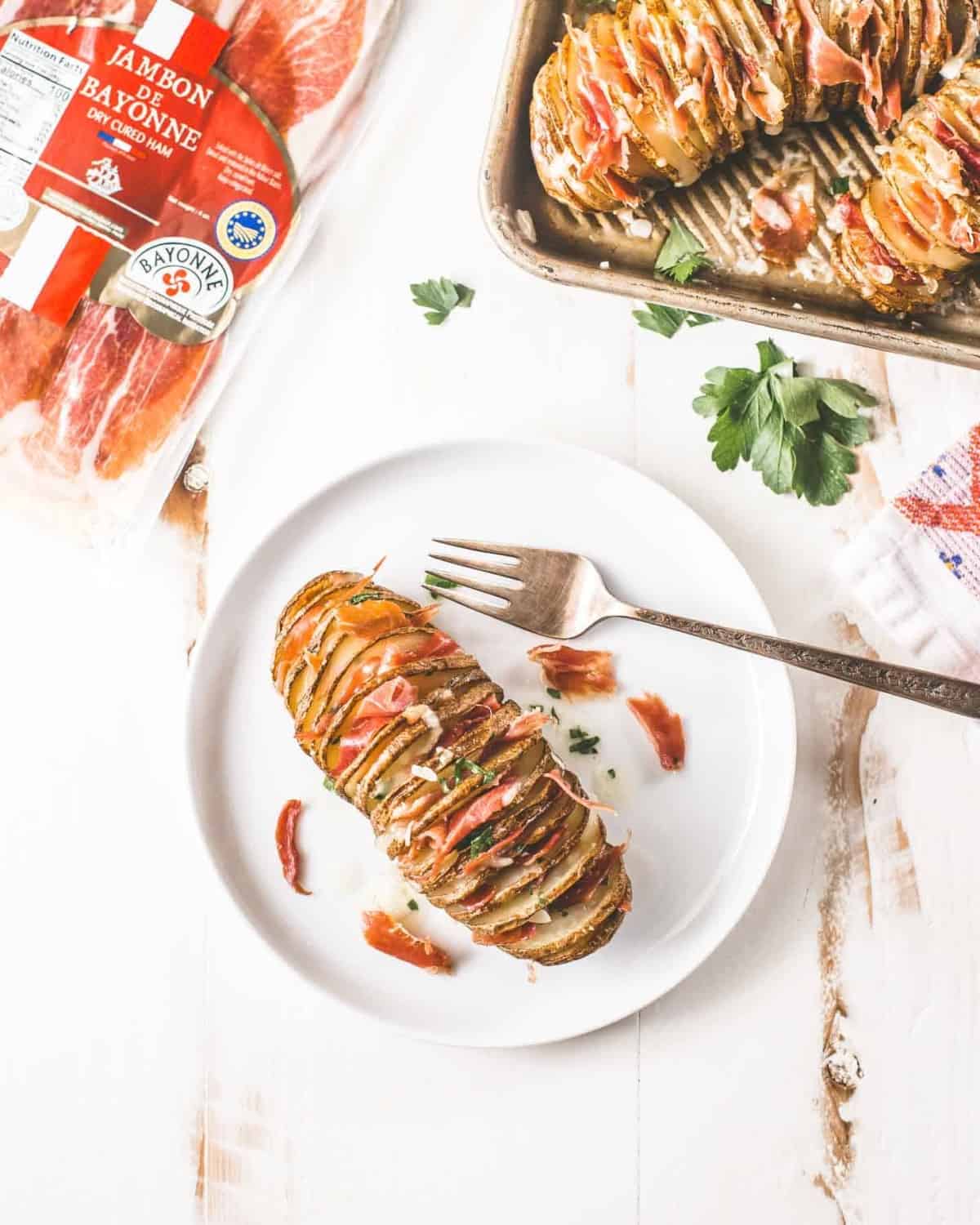 Ham and Cheese Hasselback Potato on a white plate