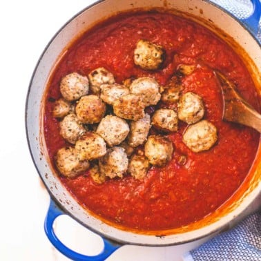 Italian Turkey Meatballs in marinara sauce in a blue dutch oven
