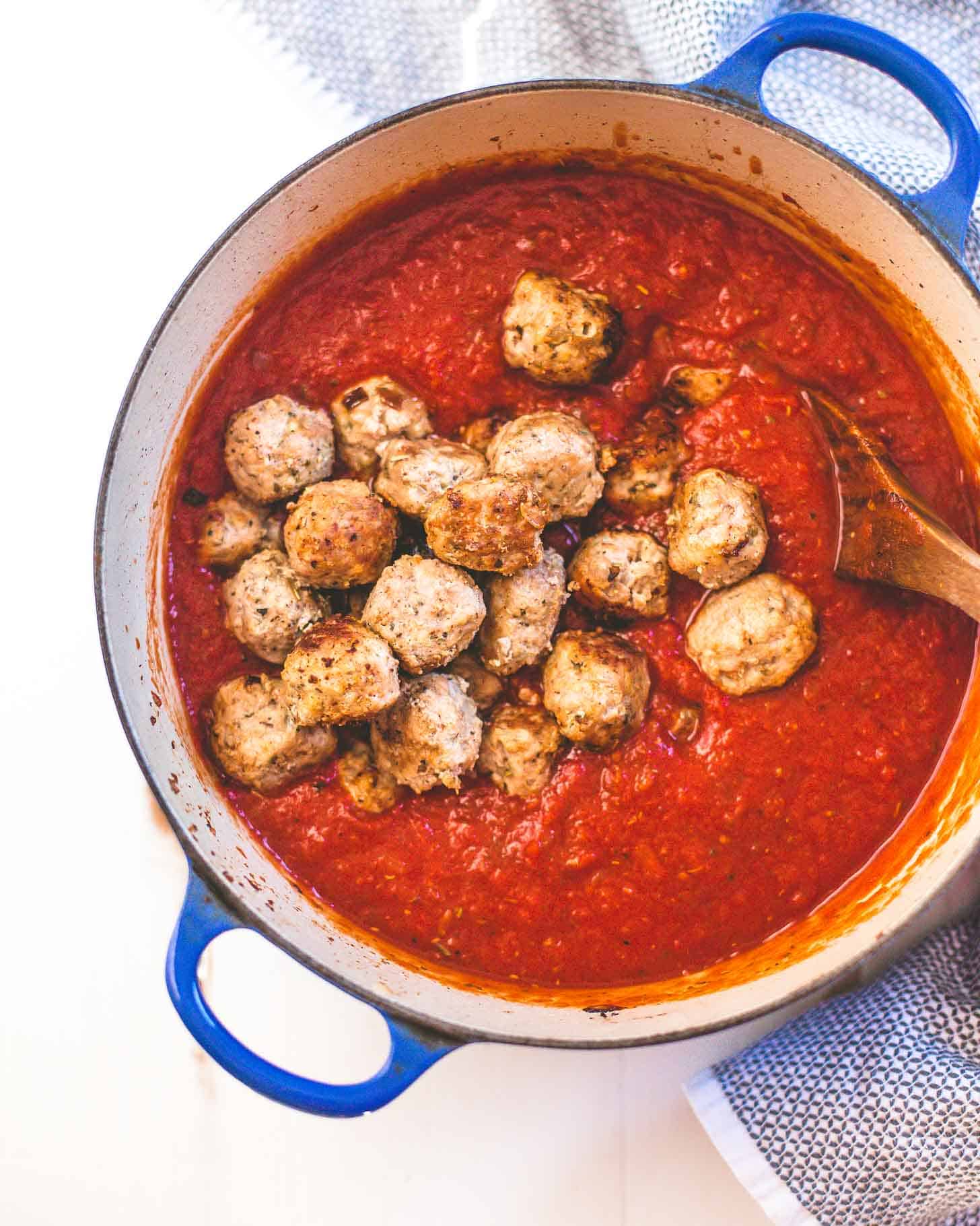 Italian Turkey Meatballs in marinara sauce in a blue dutch oven