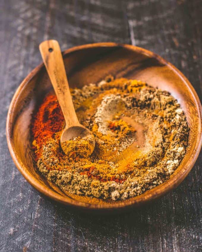 mixing spices in a small wooden bowl