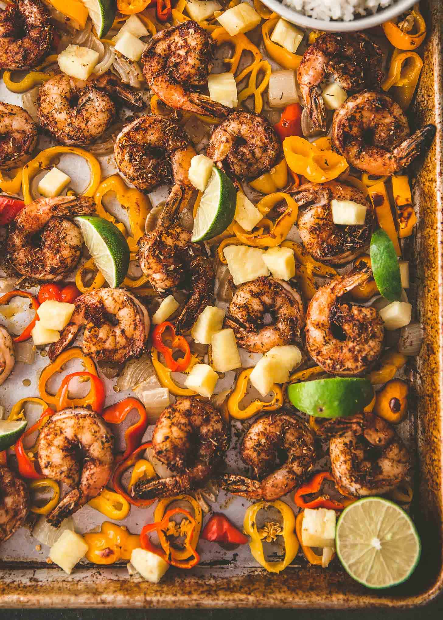 overhead image of Sheet Pan Jerk Shrimp, onions and peppers on a sheet pan