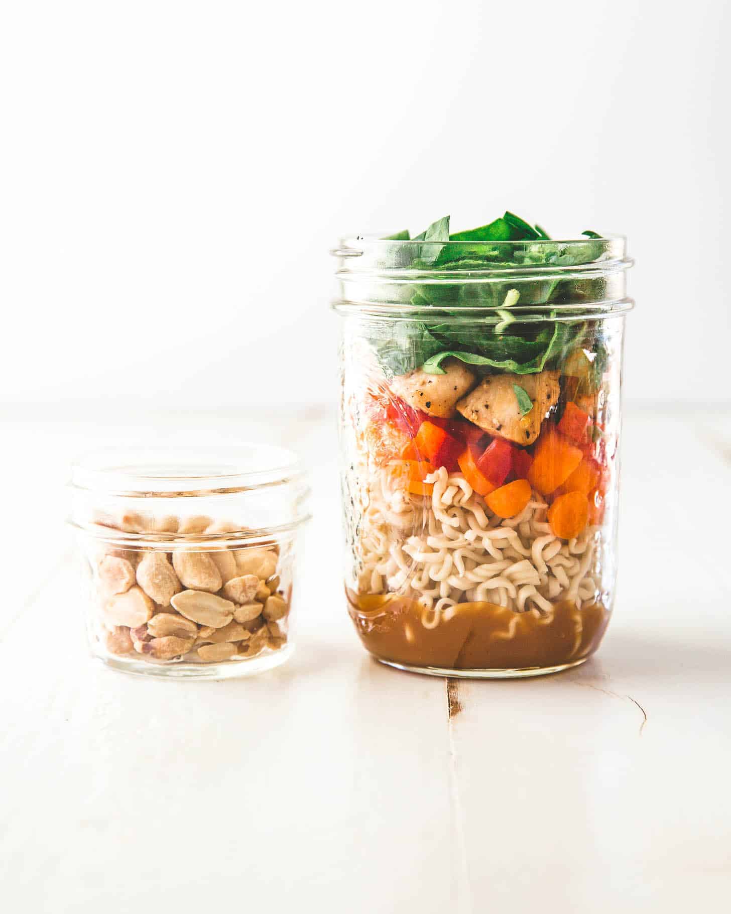 Thai Noodle Mason Jar next to a small jar of peanuts