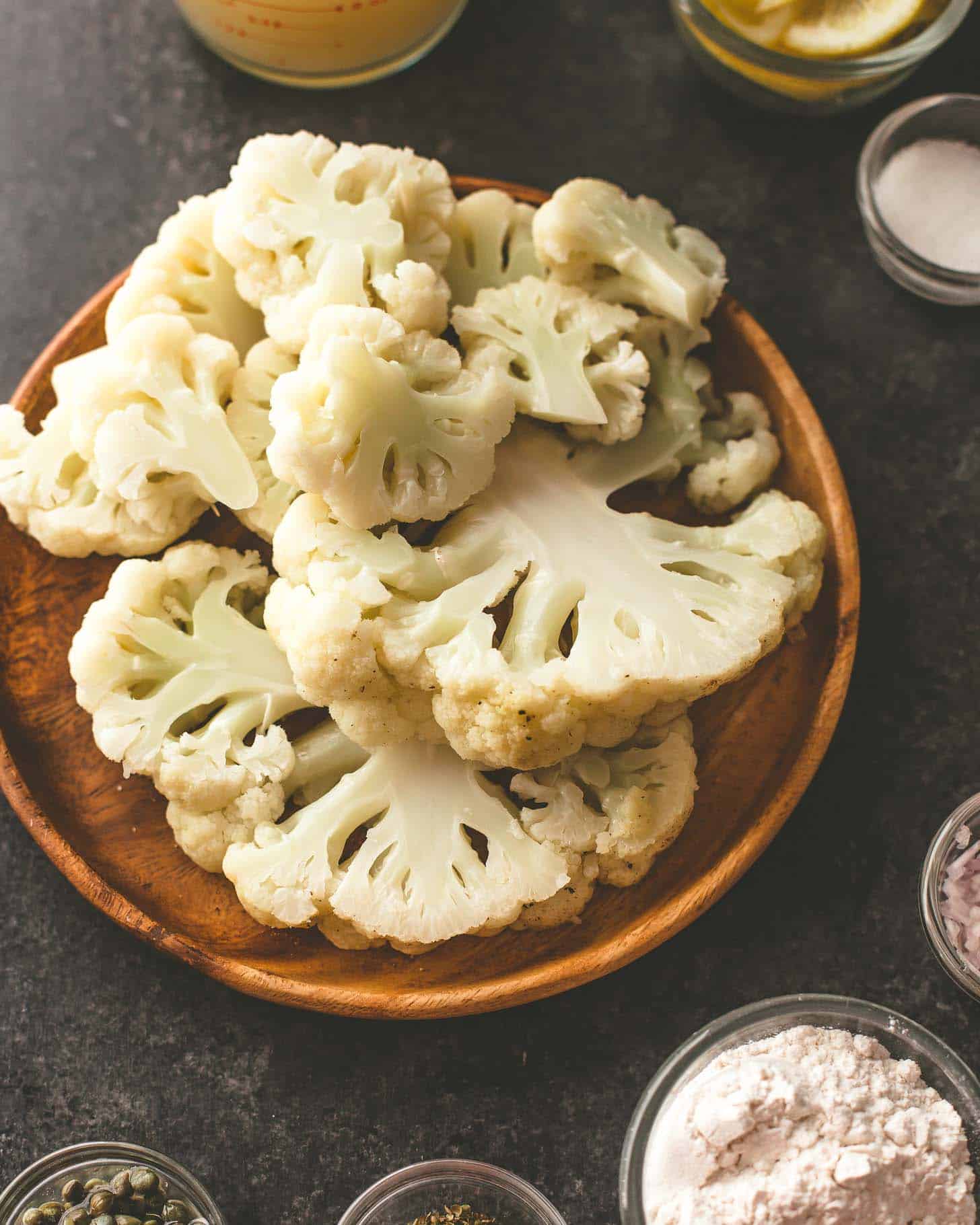 steamed cauliflower florets on a wooden tray