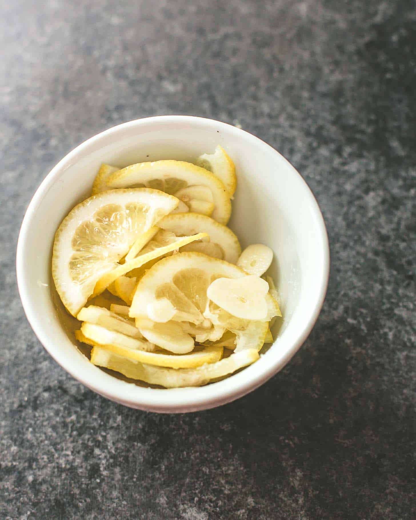 overhead image of lemon slices in a small white bowl