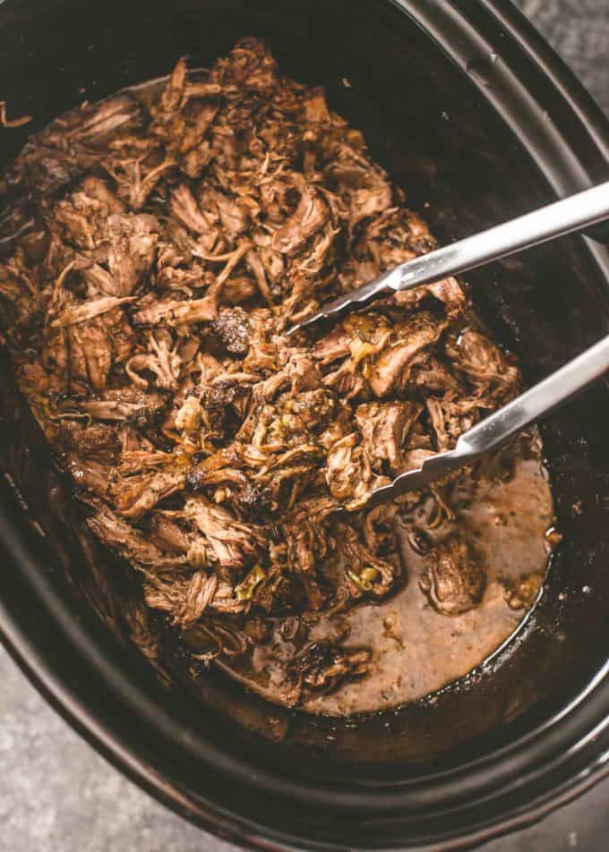 Mississippi Roast in a slow cooker with tongs