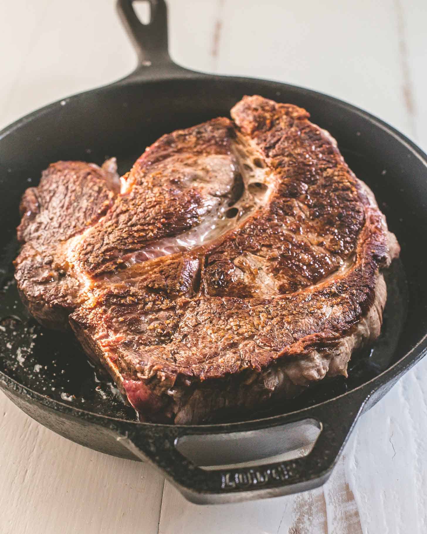 overhead image of a roast browning in a skillet