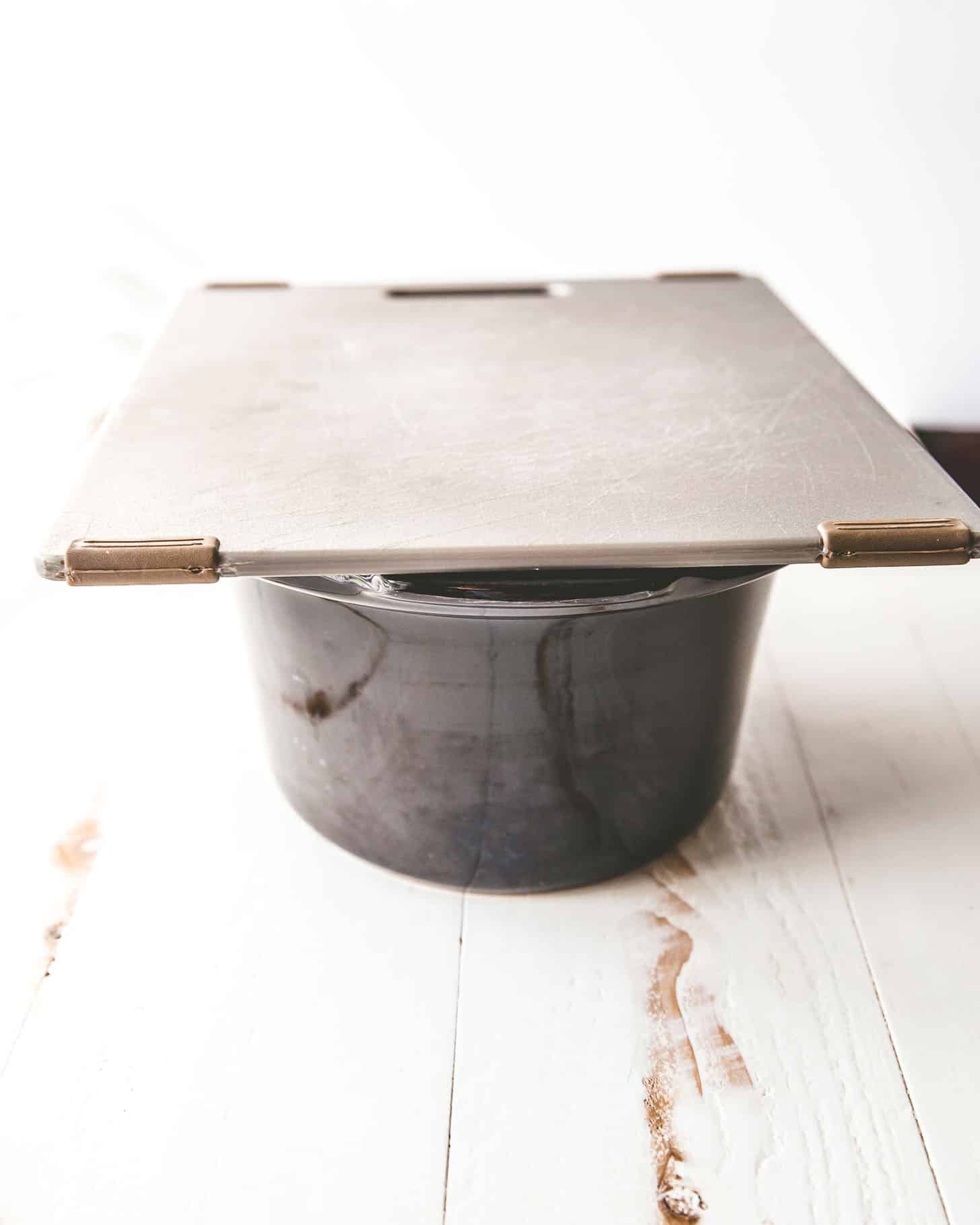 cutting board on the bowl of the slow cooker