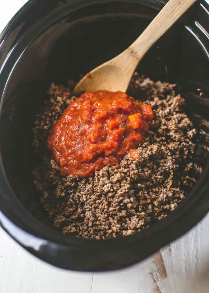 adding salsa to ground beef in the slow cooker