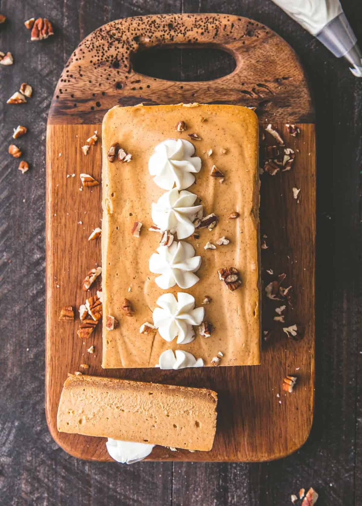Slow Cooker Pumpkin Cheesecake on a wooden tray