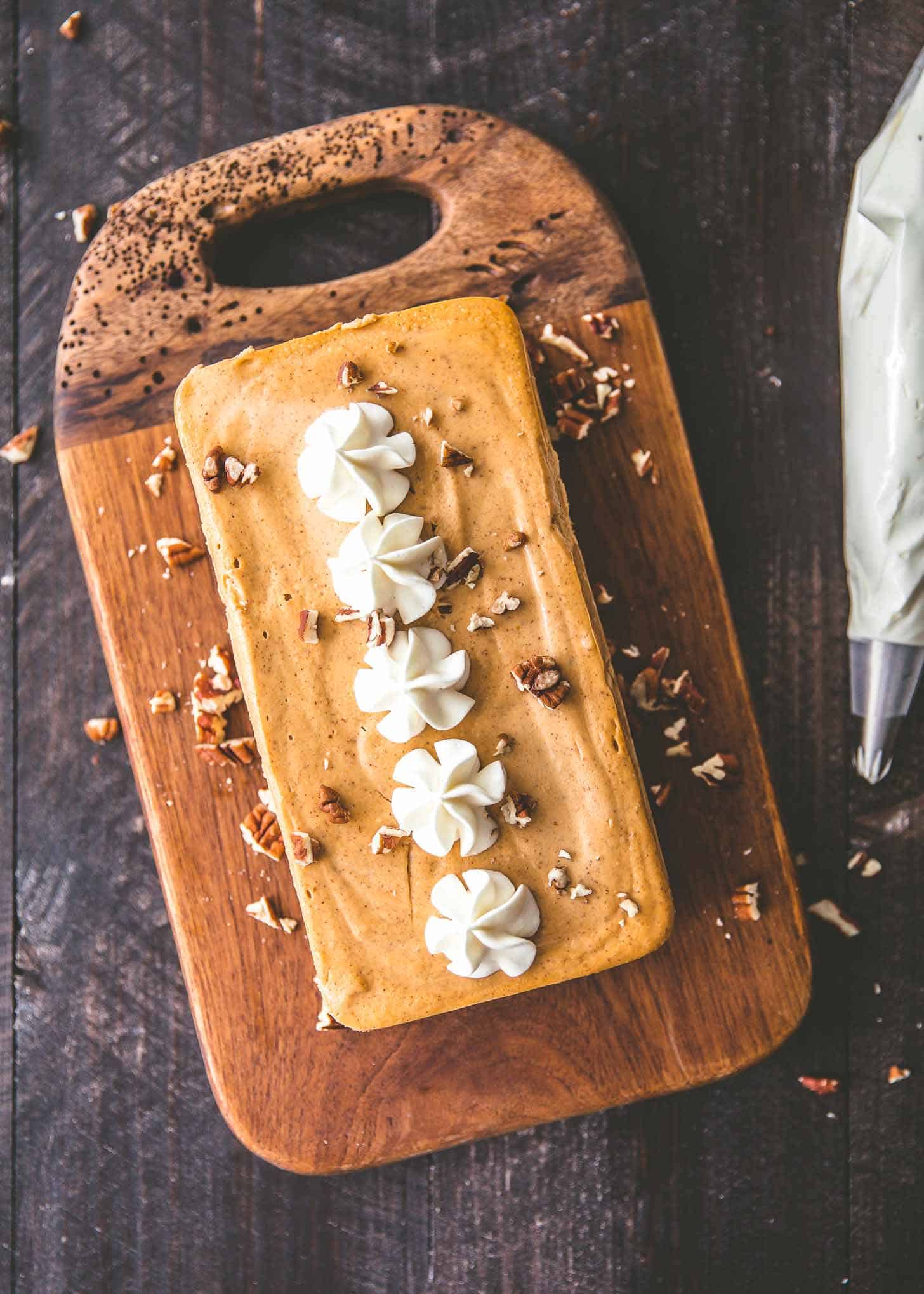 overhead image of Slow Cooker Pumpkin Cheesecake on a wooden tray