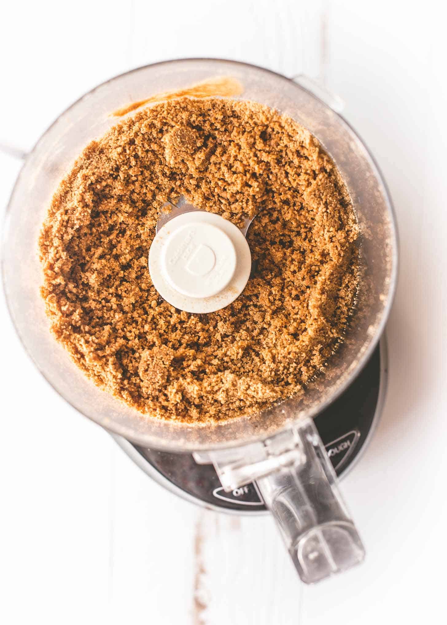 overhead image of graham cracker crumbs in a food processor