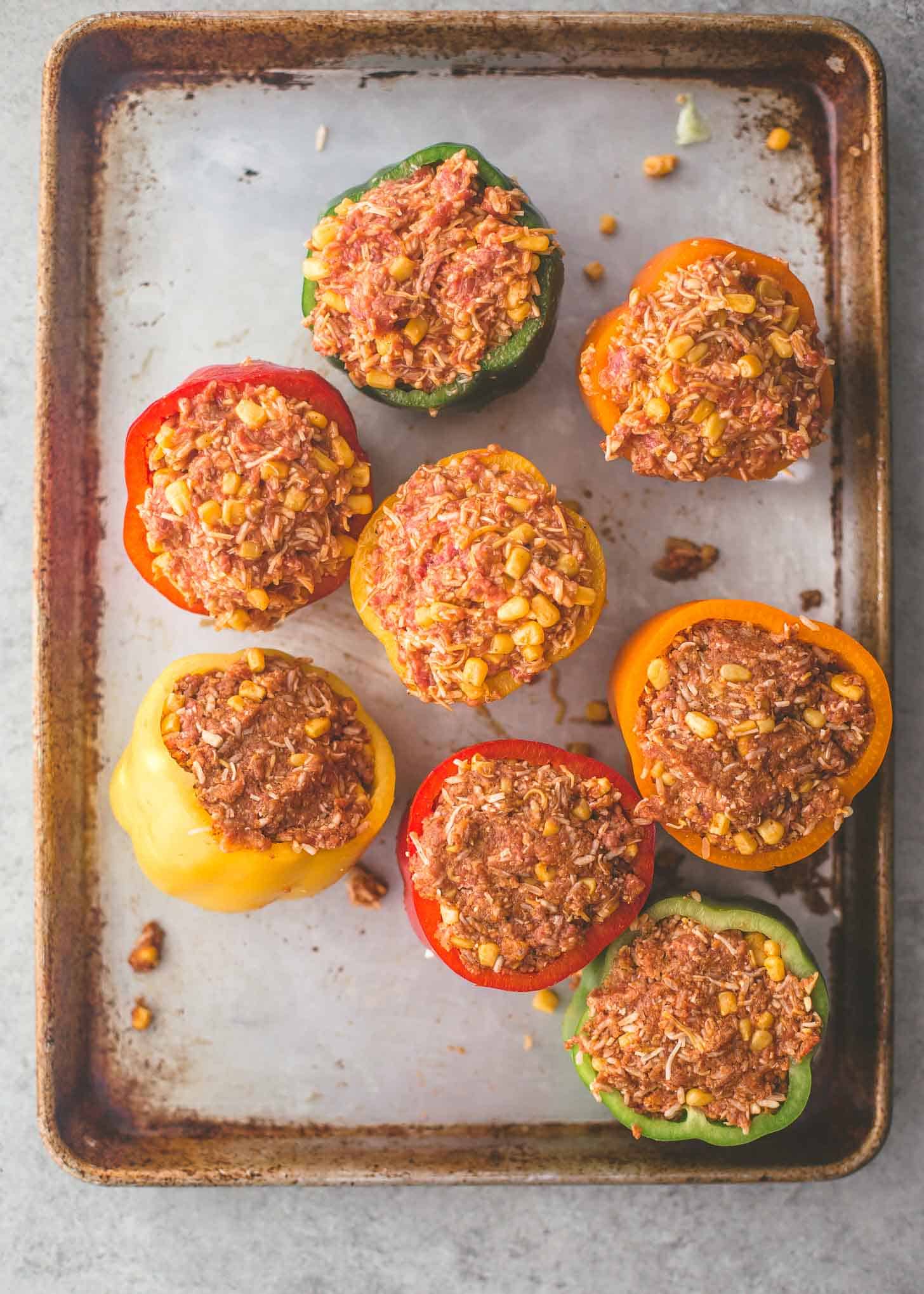 overhead image of uncooked Tex Mex Stuffed Peppers on a sheet pan