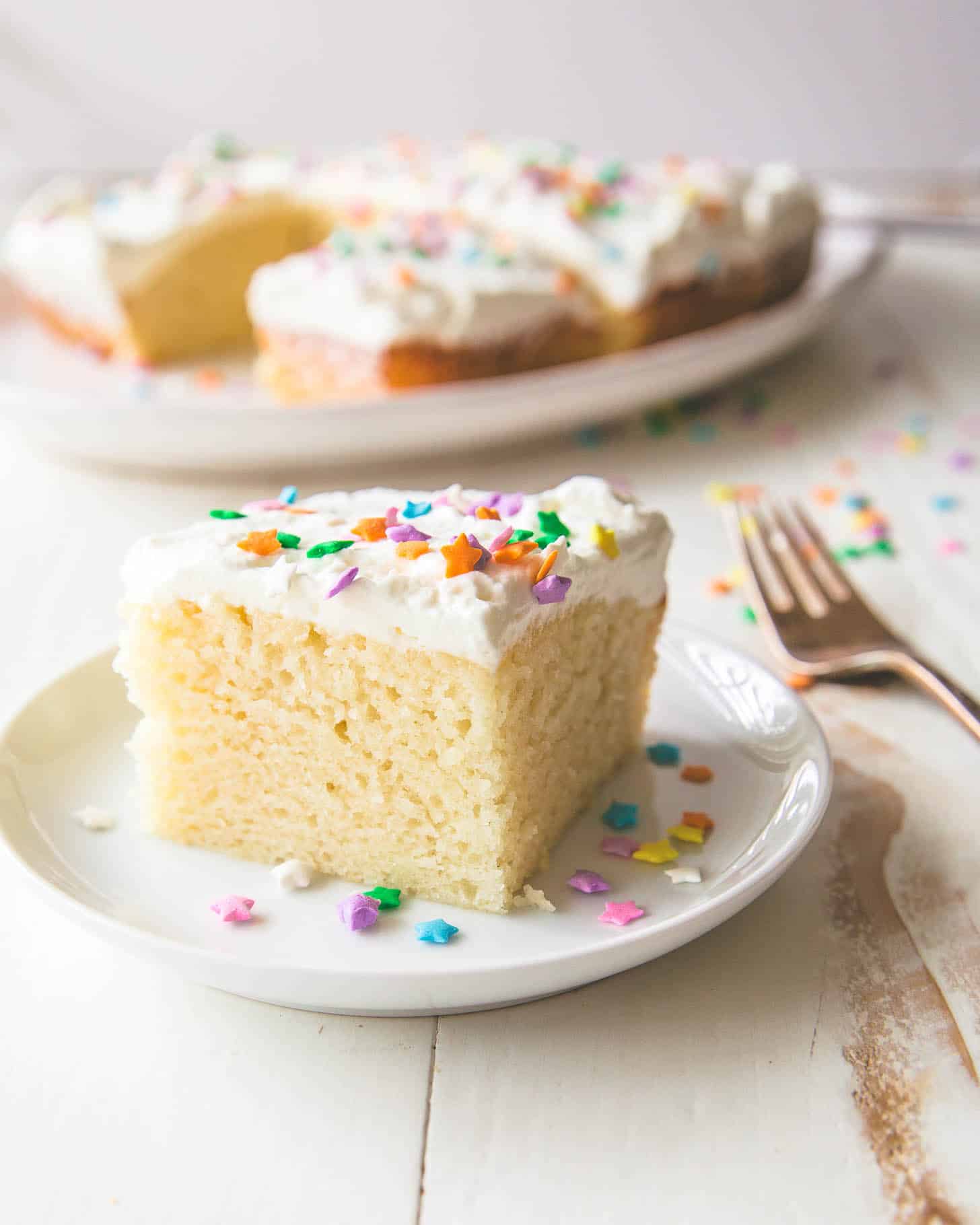 a piece of vanilla cake on a white plate