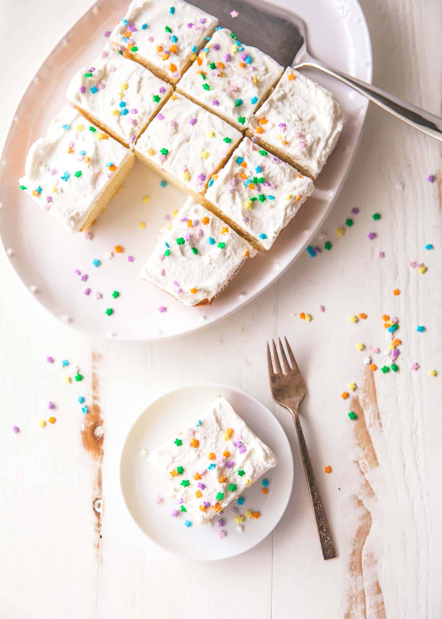 vanilla cake cut into pieces on a white tray