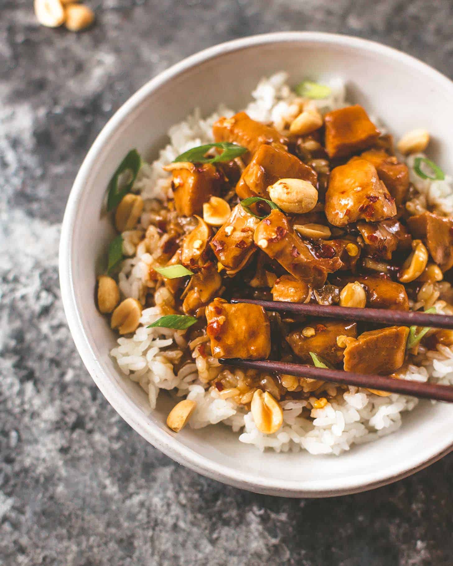 instant pot kung pao chicken over rice with chopsticks