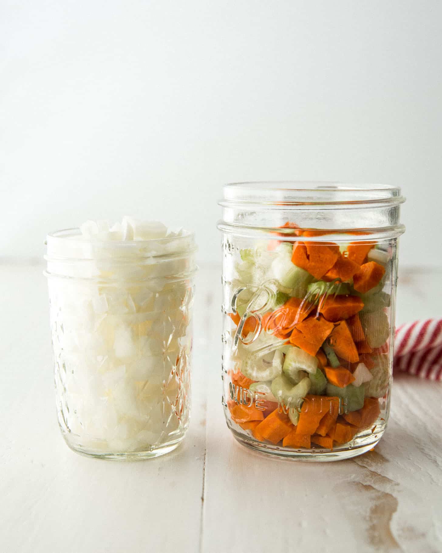 chopped onions and vegetables in mason jars