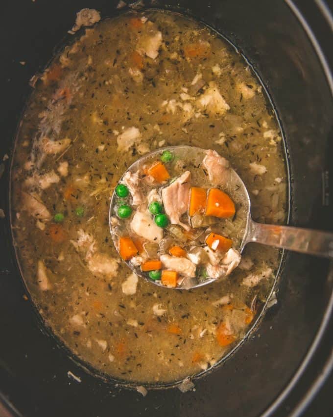 chicken broth in a slow cooker with vegetables