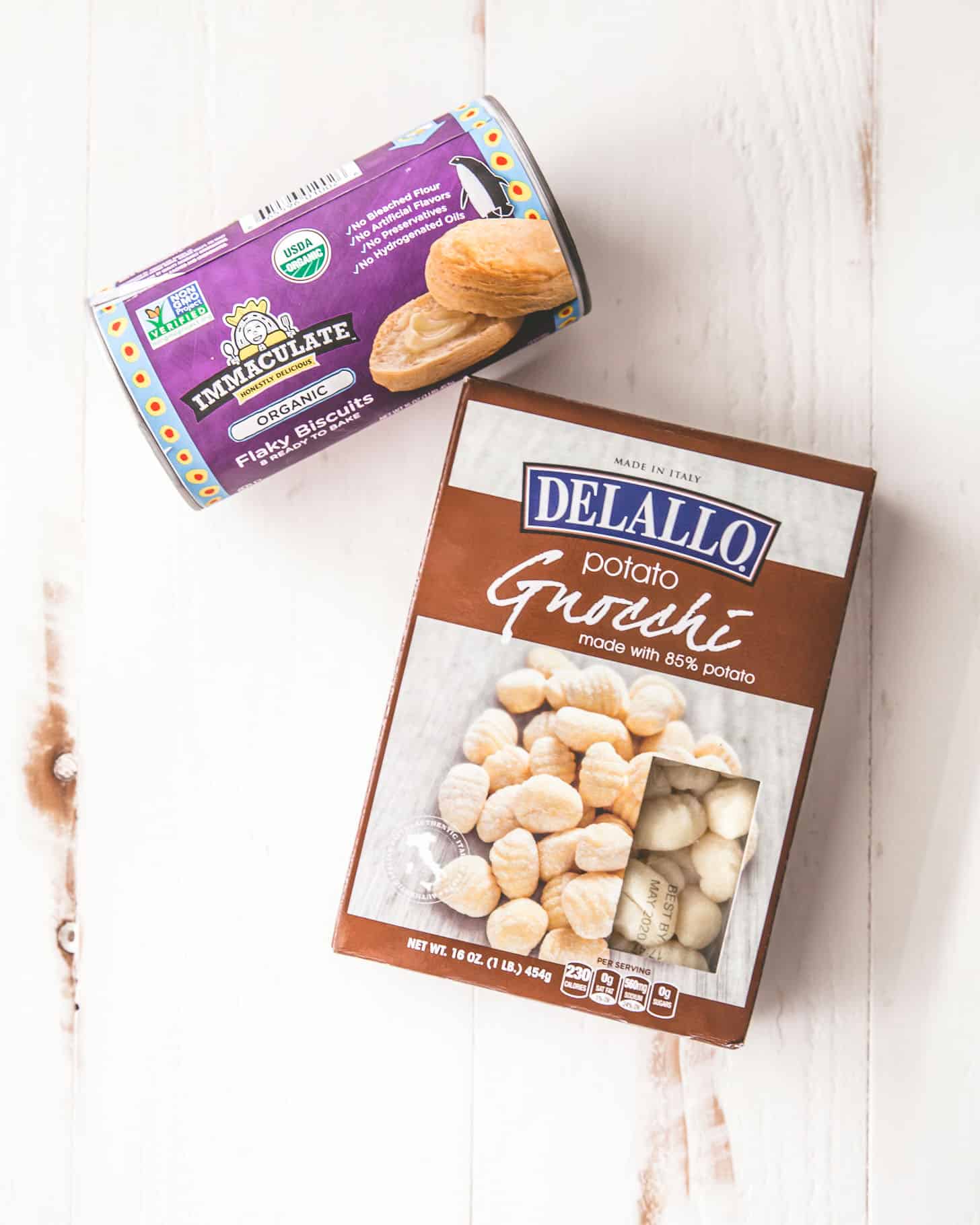 overhead image of canned biscuits and gnocchi on a white table