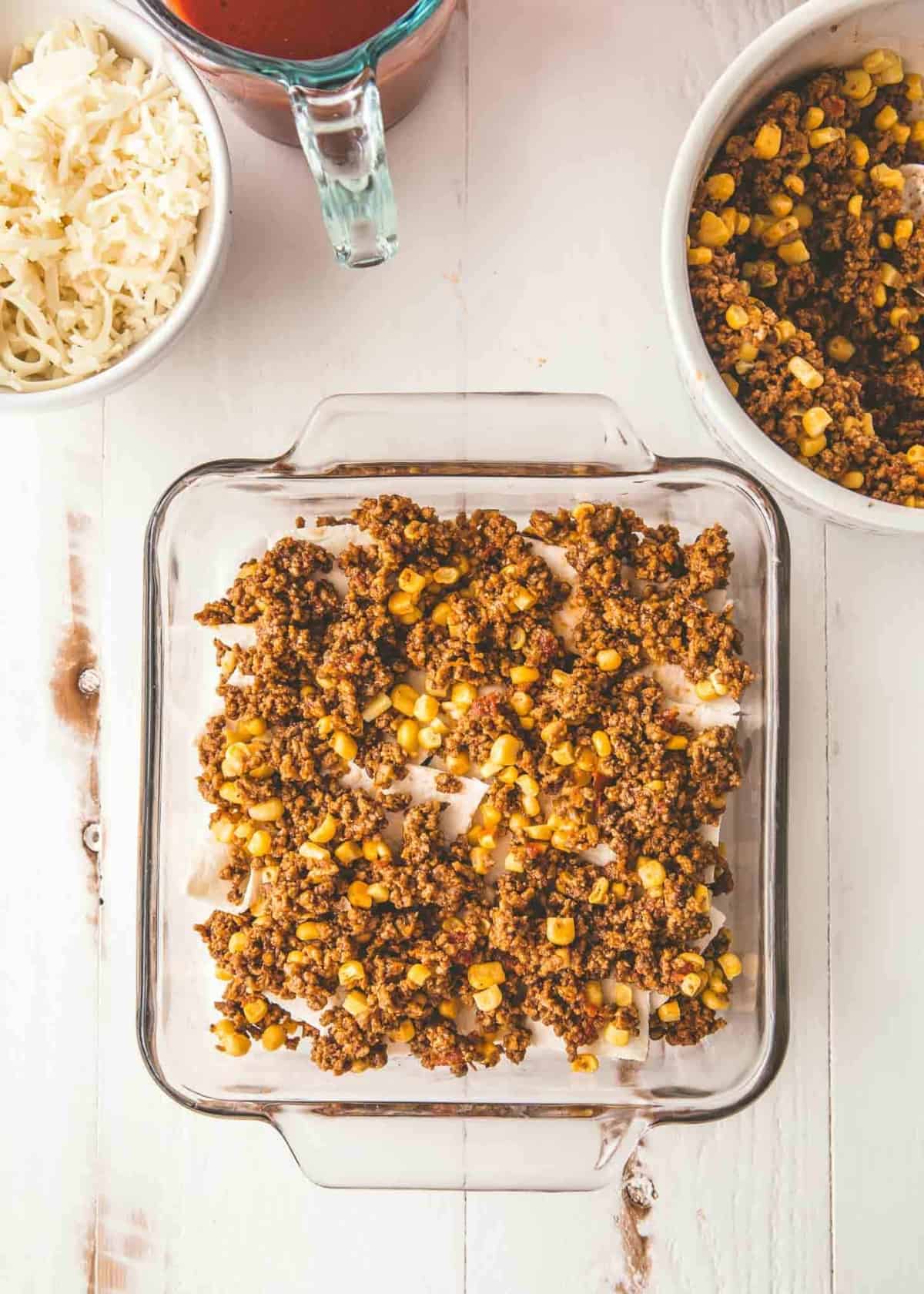 taco casserole in a clear baking dish