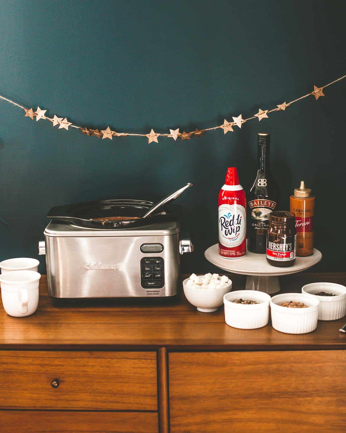 hot chocolate and mix ins on a wooden shelf