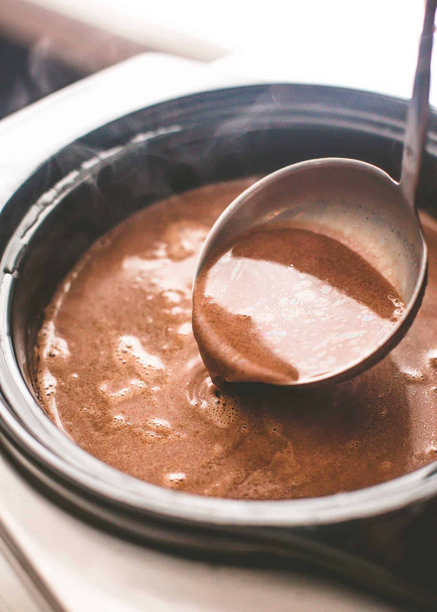 a ladle in a slow cooker of hot chocolate
