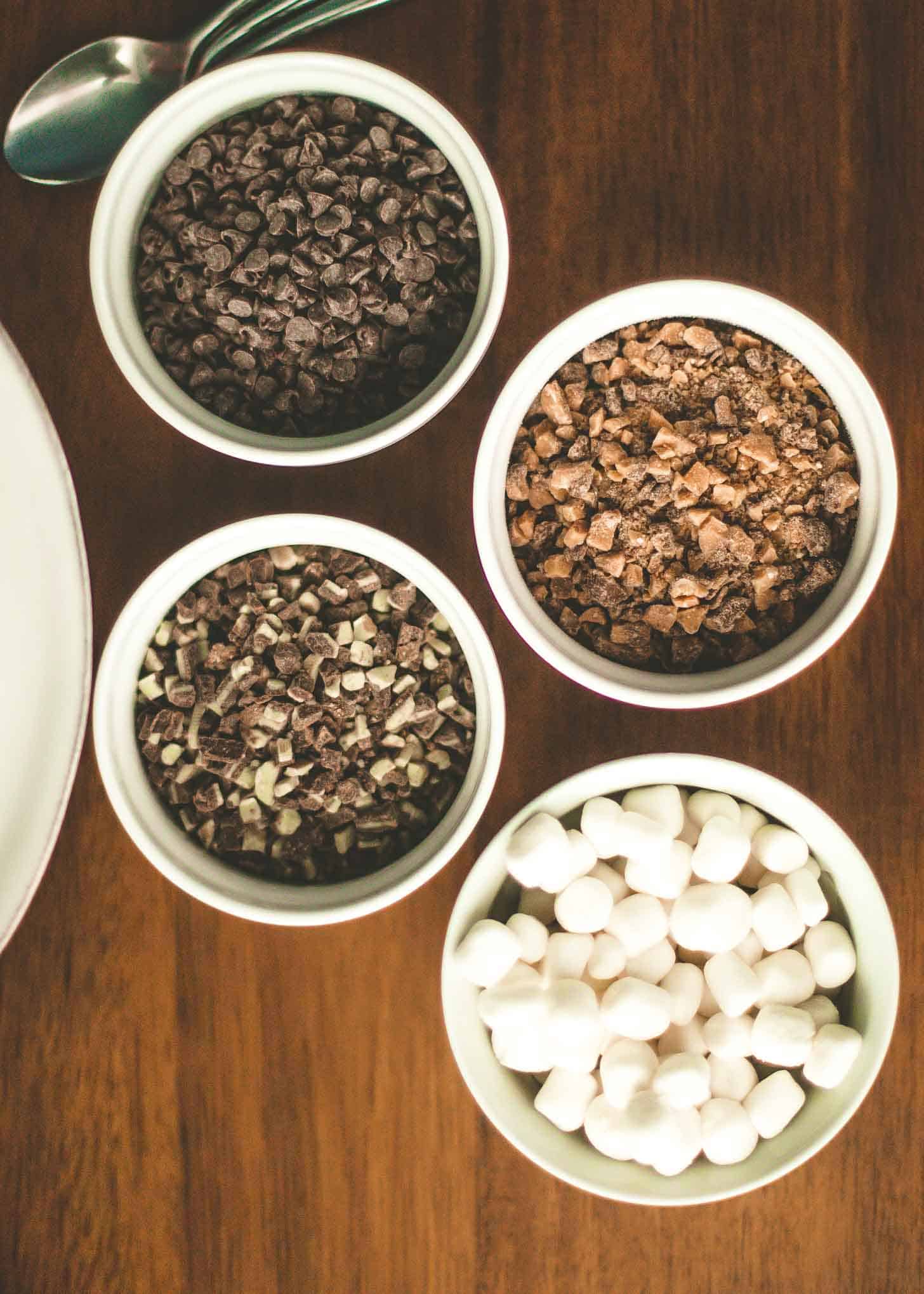 overhead view of toppings for hot chocolate in small white ramekins